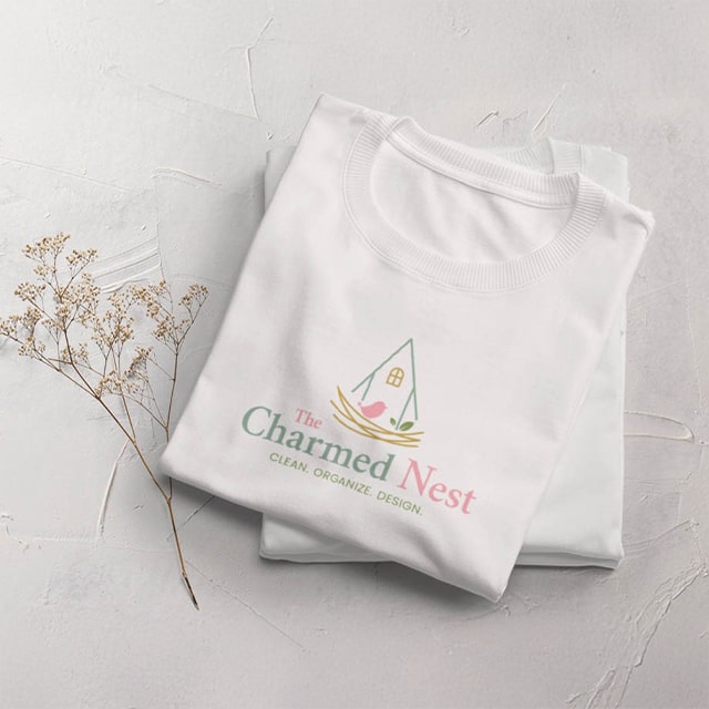 A white sweatshirt with The Charmed Nest logo and the tagline Clean, Organize, Design.