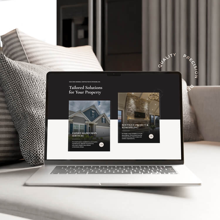 A laptop on a bed displays a website about property services, featuring sections for handyman services and remodeling projects. Neutral pillows and a blanket are seen in the background.