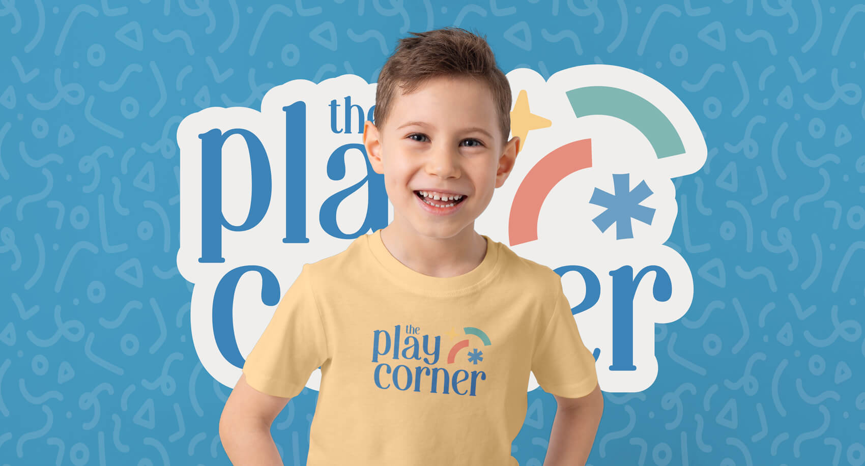 A young boy wearing a yellow shirt with the logo.