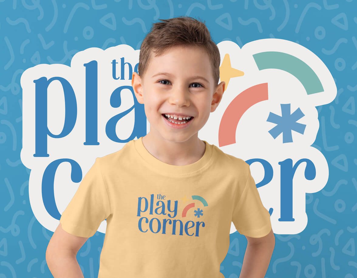 A young boy wearing a yellow shirt with the logo.