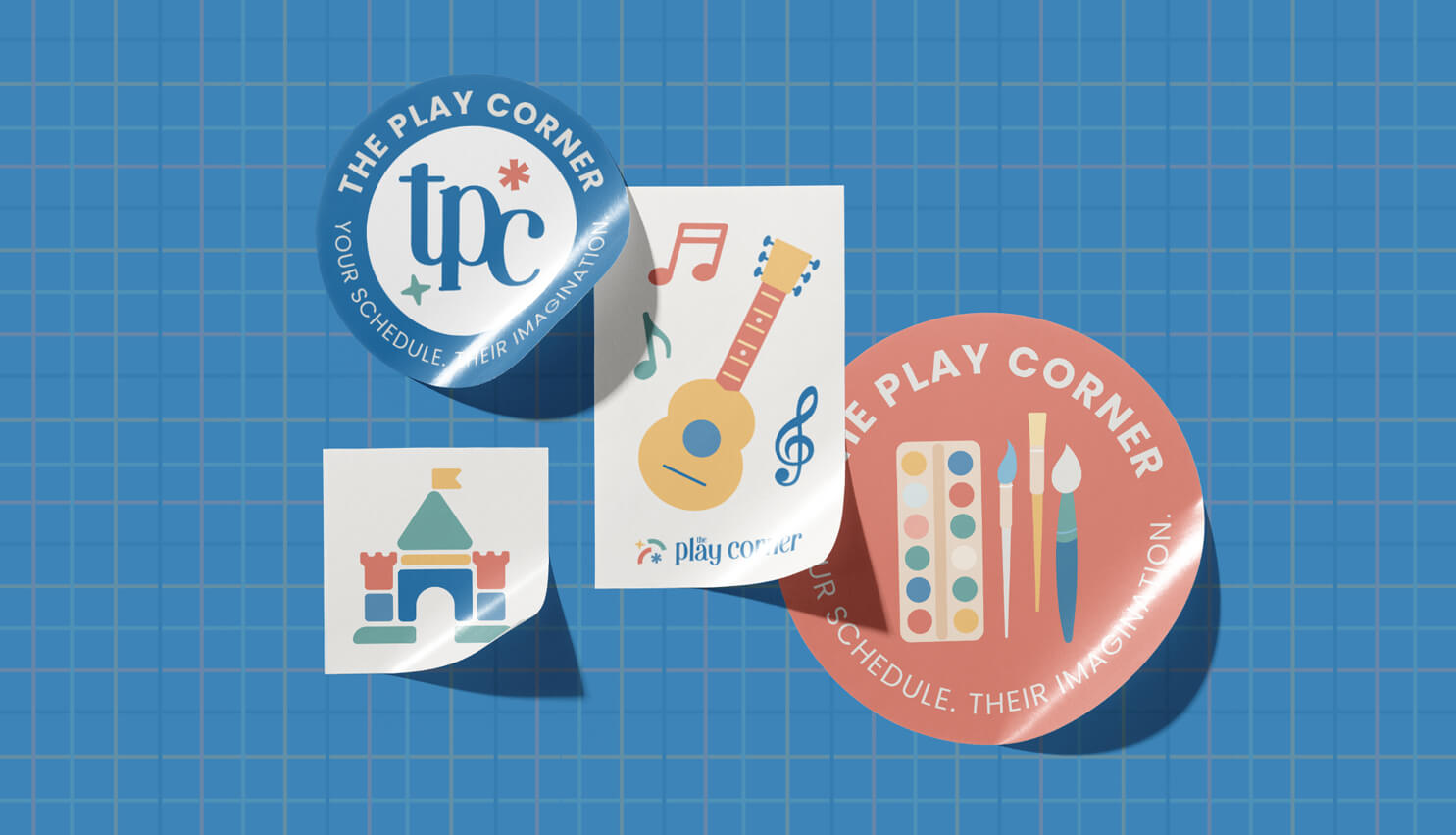 Four colorful stickers on a blue grid background, featuring The Play Corner sub logos, a guitar with musical notes, a paint palette, and a toy castle illustration.